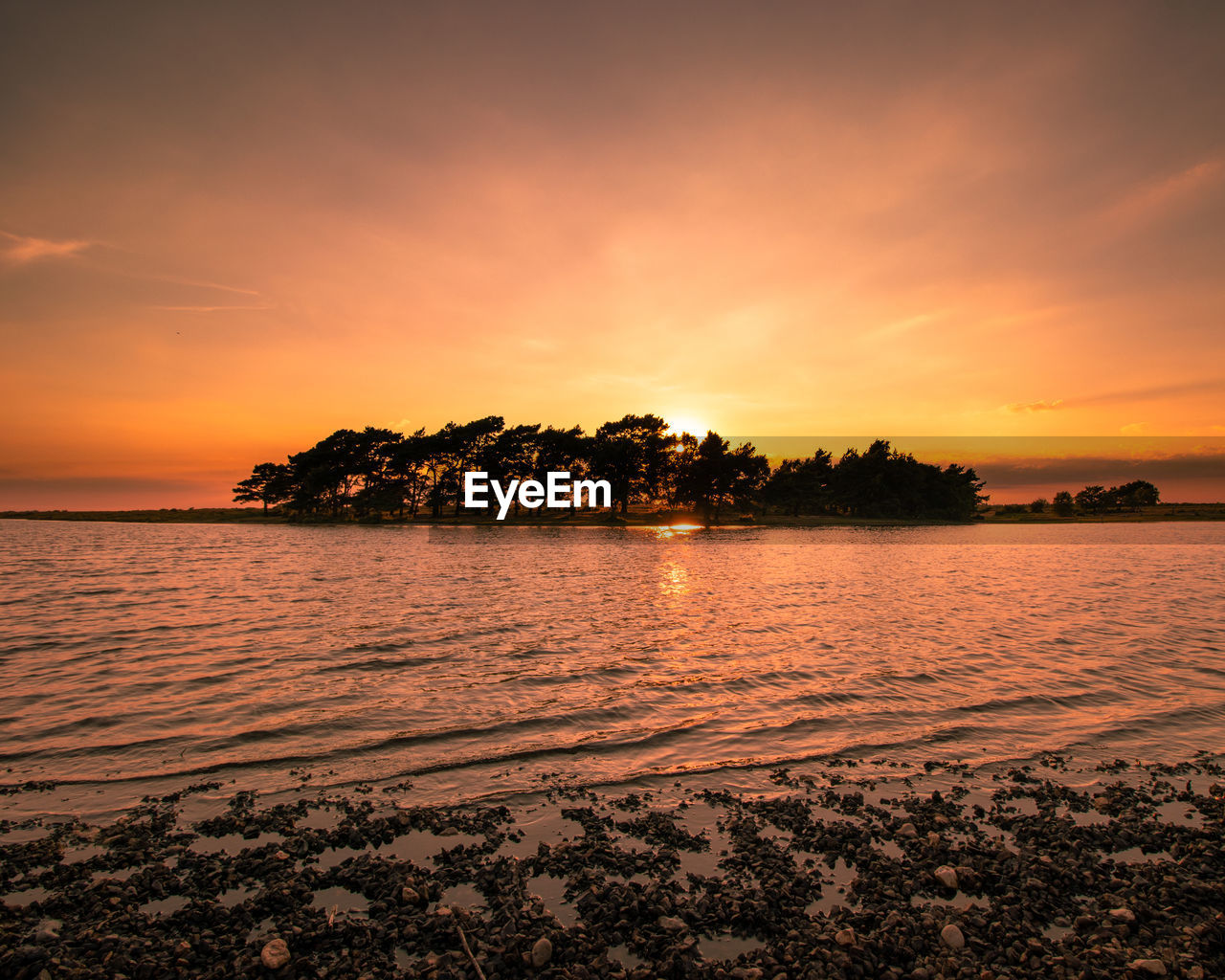 Scenic view of sea against orange sky