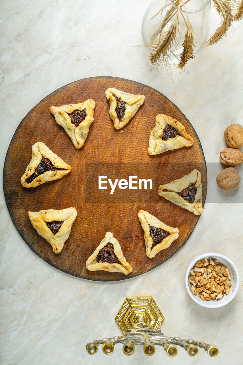 Gomentashi cookies traditional for the jewish holiday of purim on a round board on the table 
