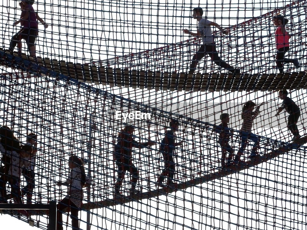 High angle view of people walking on fence