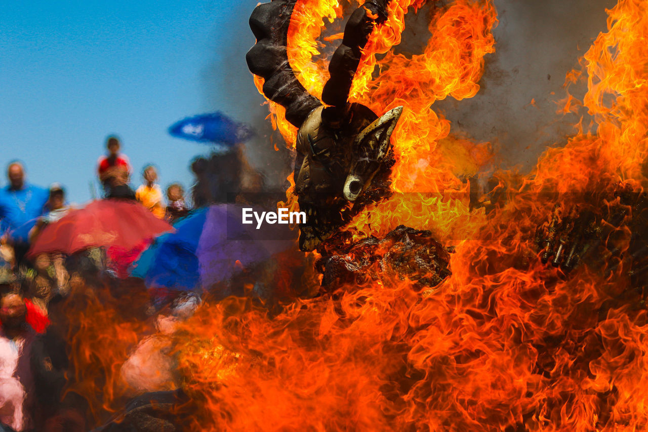 fire, burning, flame, heat, nature, group of people, person, communication, bonfire, men, adult, outdoors, warning sign, sign, motion