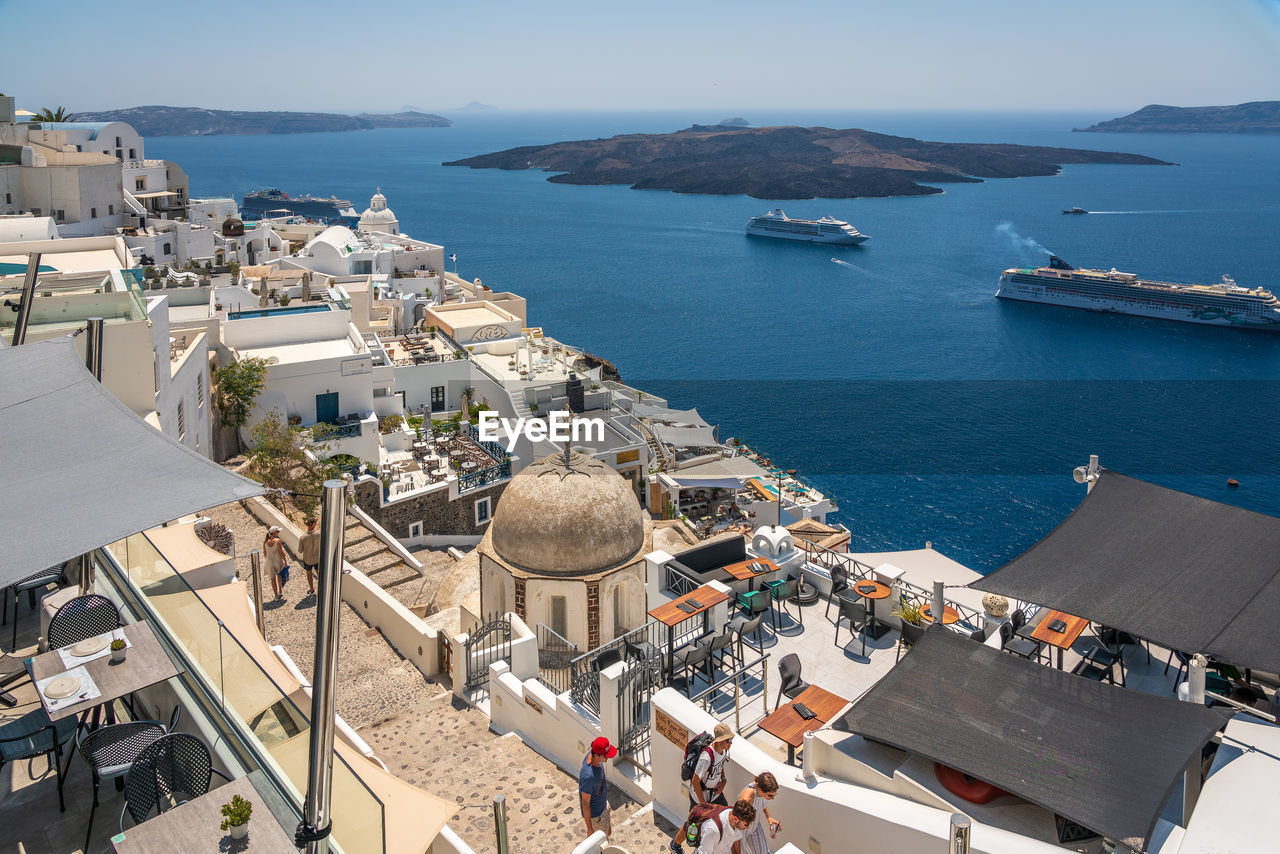 High angle view of city by sea with cruise ship