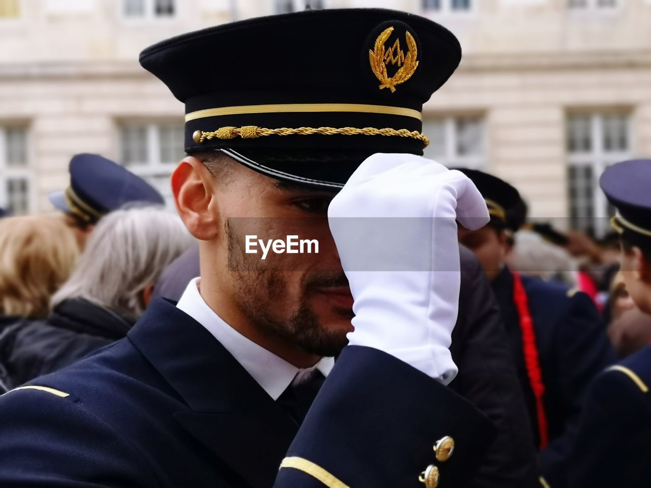 Close-up of sailor in military uniform standing on street