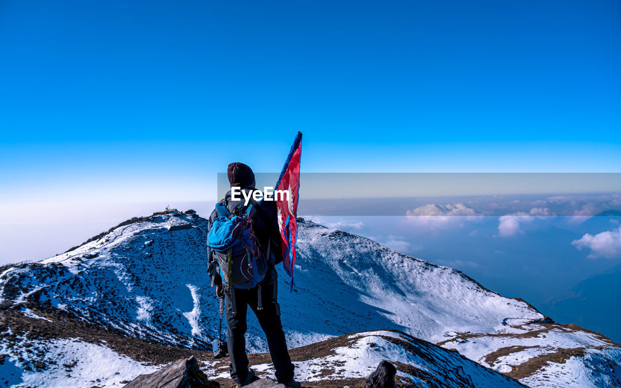 rear view of woman standing on mountain