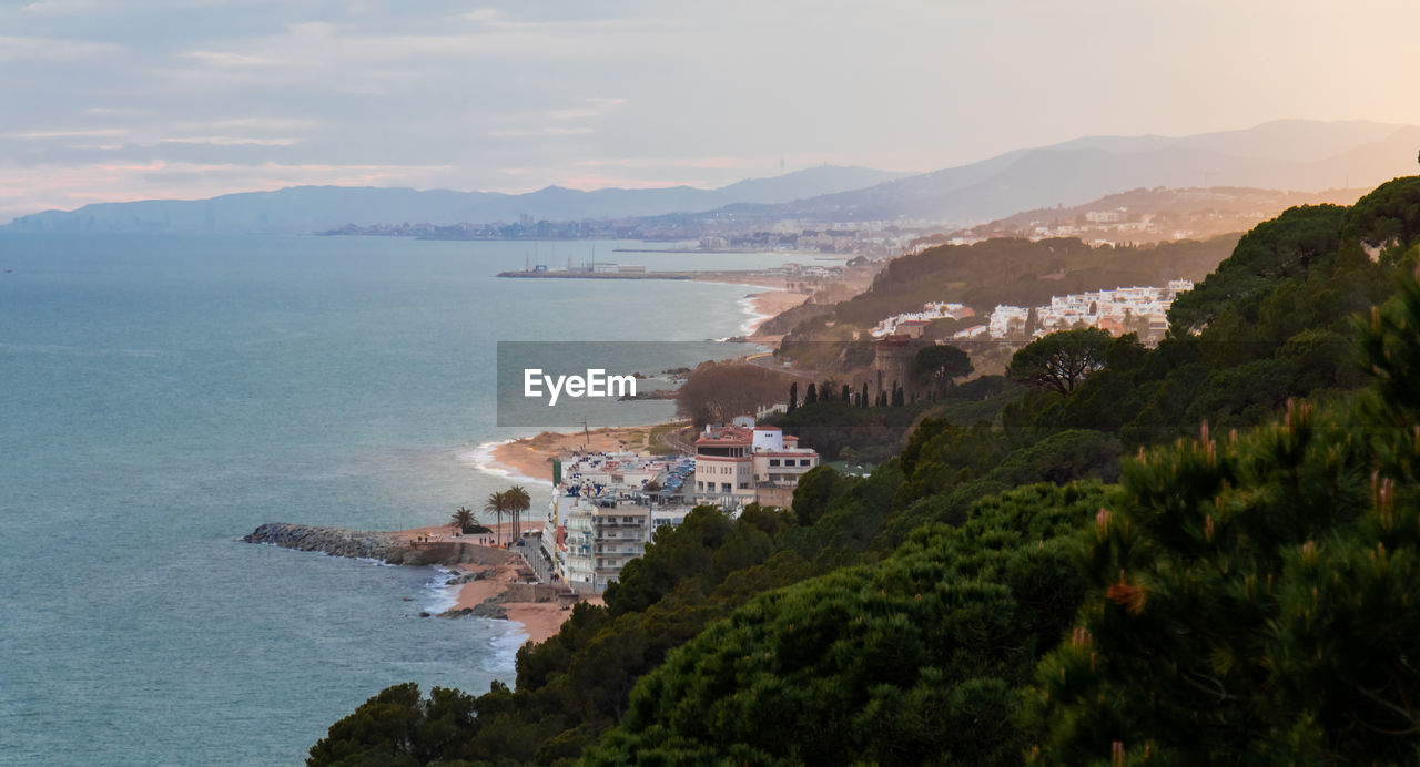 High angle view of buildings by sea against sky