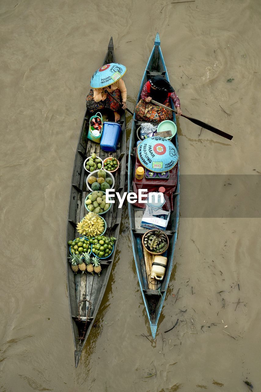 High angle view of vendors with food for sale in boat