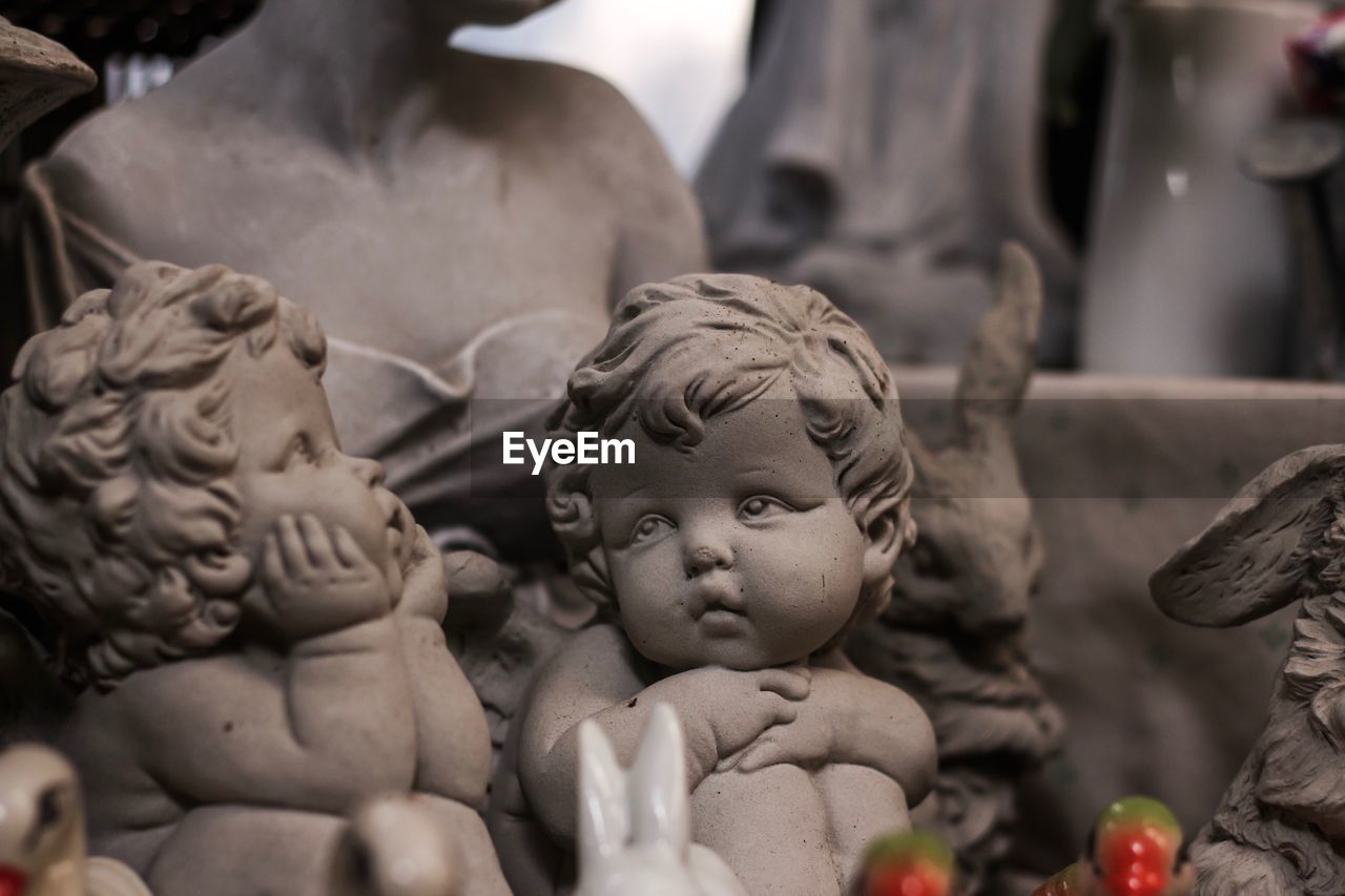 CLOSE-UP OF ANGEL STATUE AT MARKET STALL