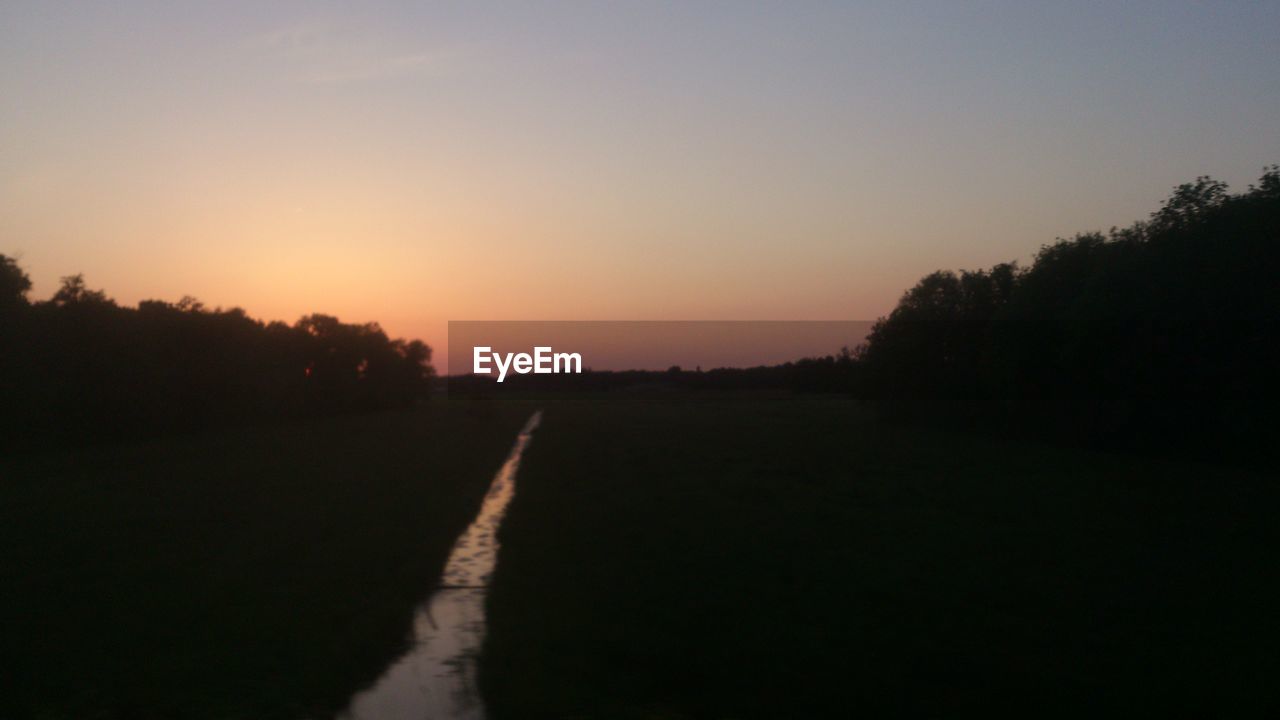 VIEW OF LANDSCAPE AT SUNSET