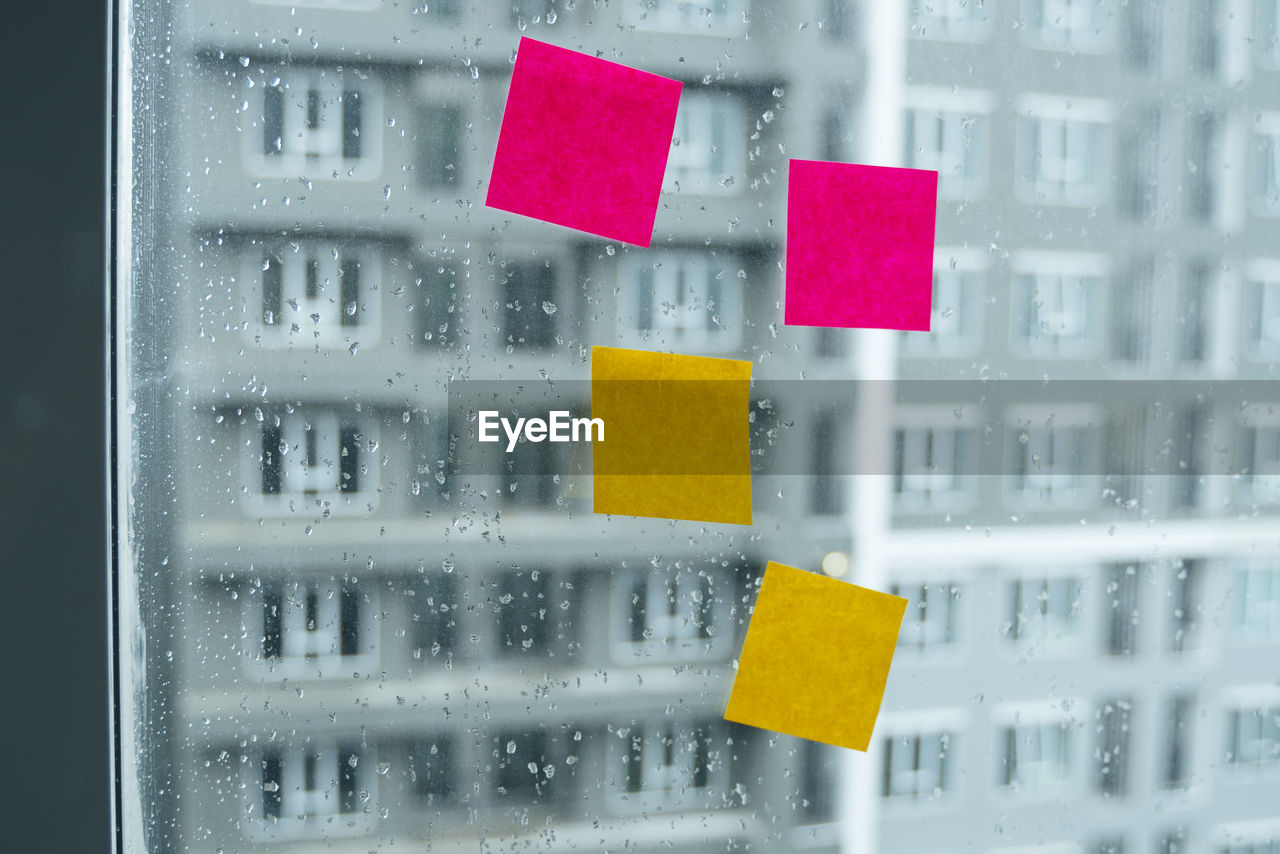 CLOSE-UP OF RAINDROPS ON GLASS WINDOW