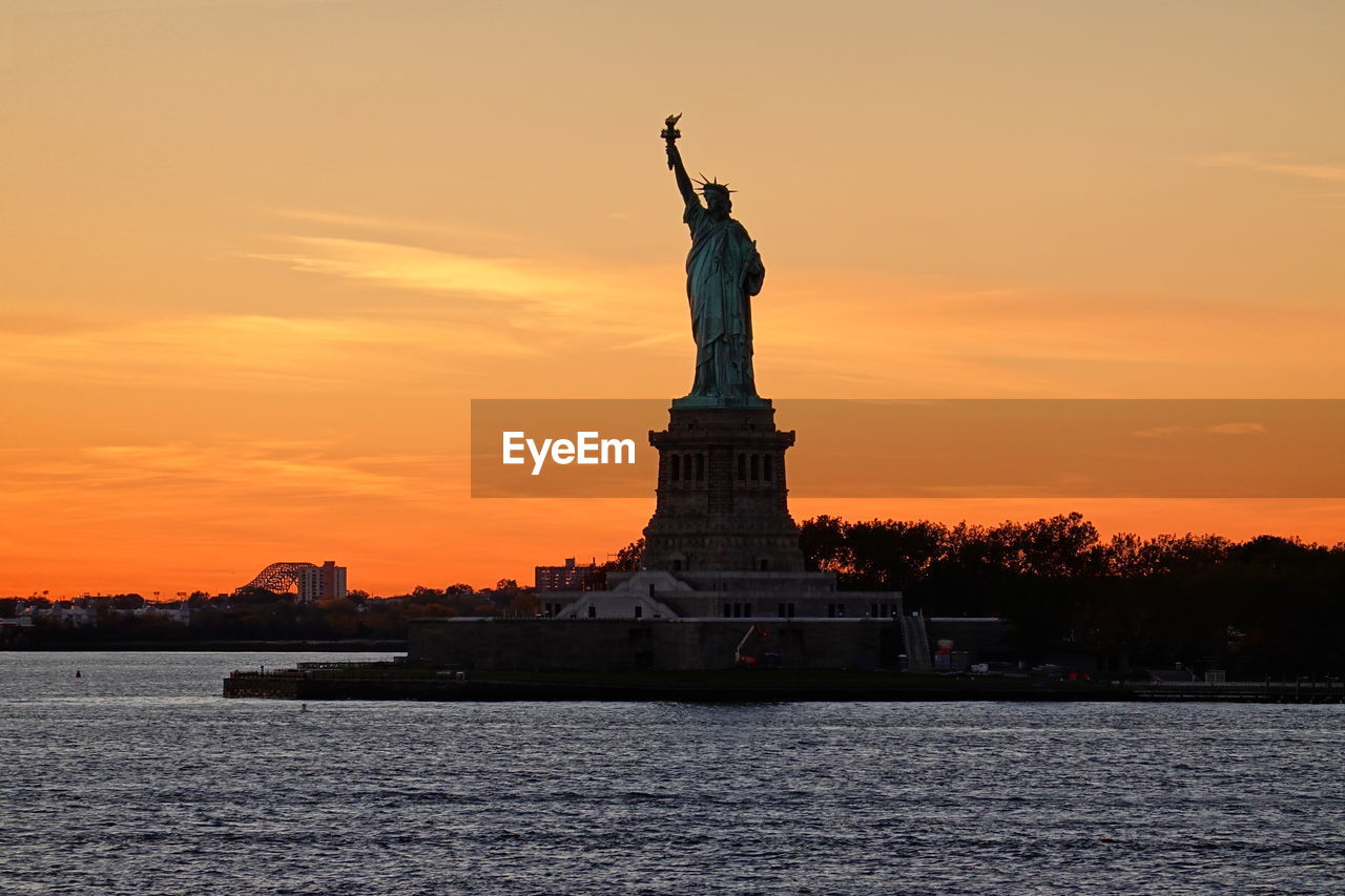 statue of liberty against sky during sunset