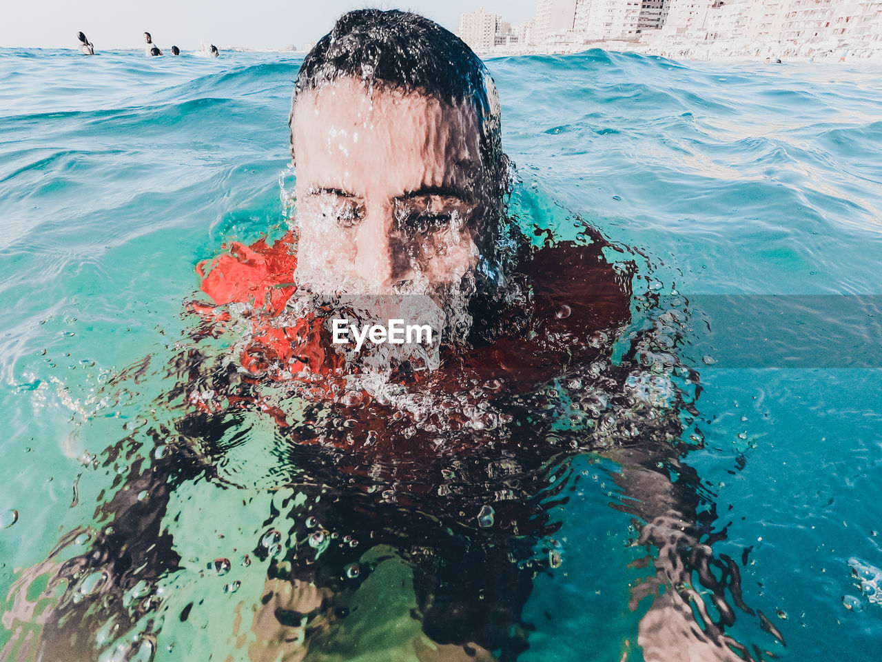 PORTRAIT OF MAN IN SWIMMING POOL