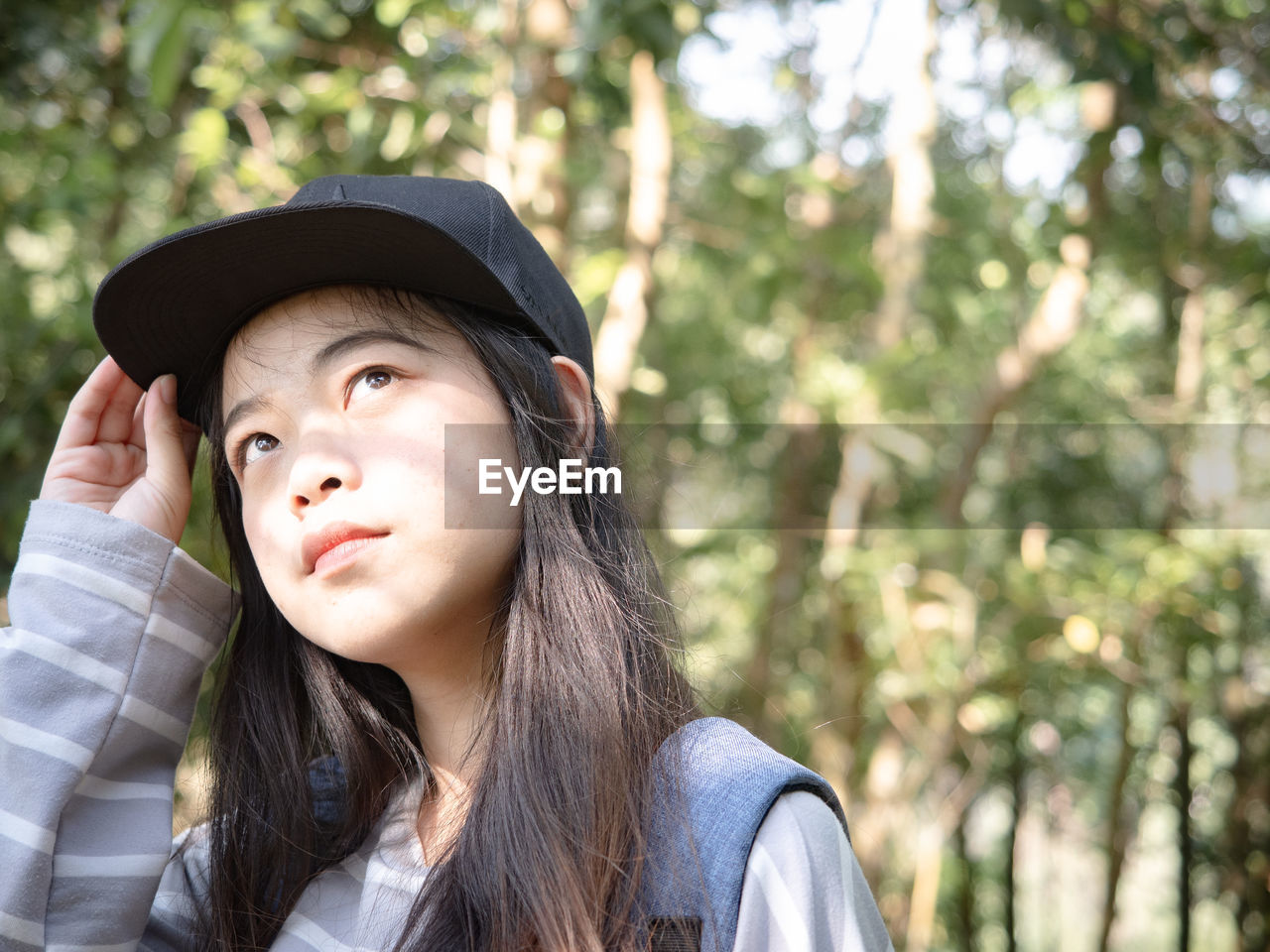 Young woman wearing cap looking away