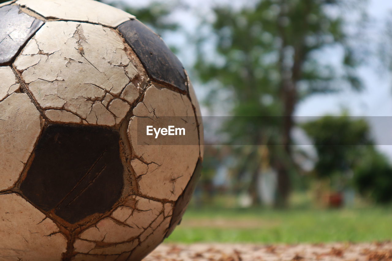 Close-up of old ball on field