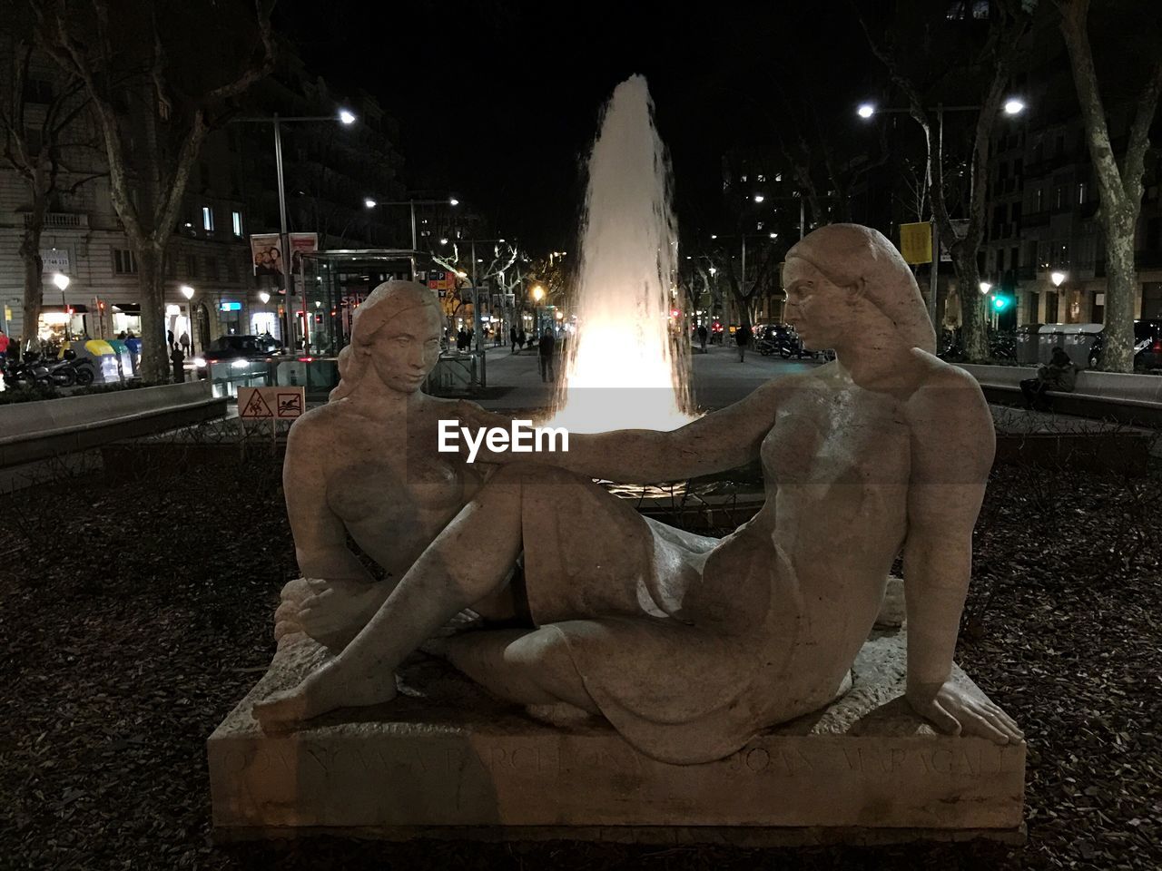 ILLUMINATED STATUE IN FRONT OF BUILDING