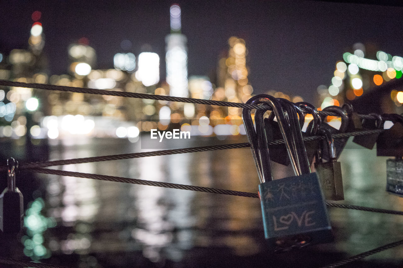 Close-up of padlocks hanging on railing