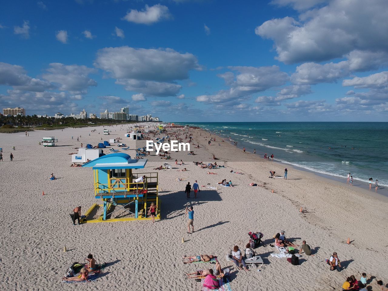 People on beach against sky