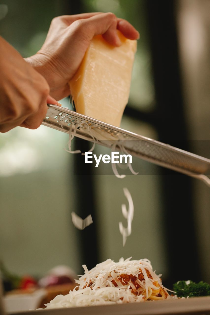 Cropped hand of person preparing food