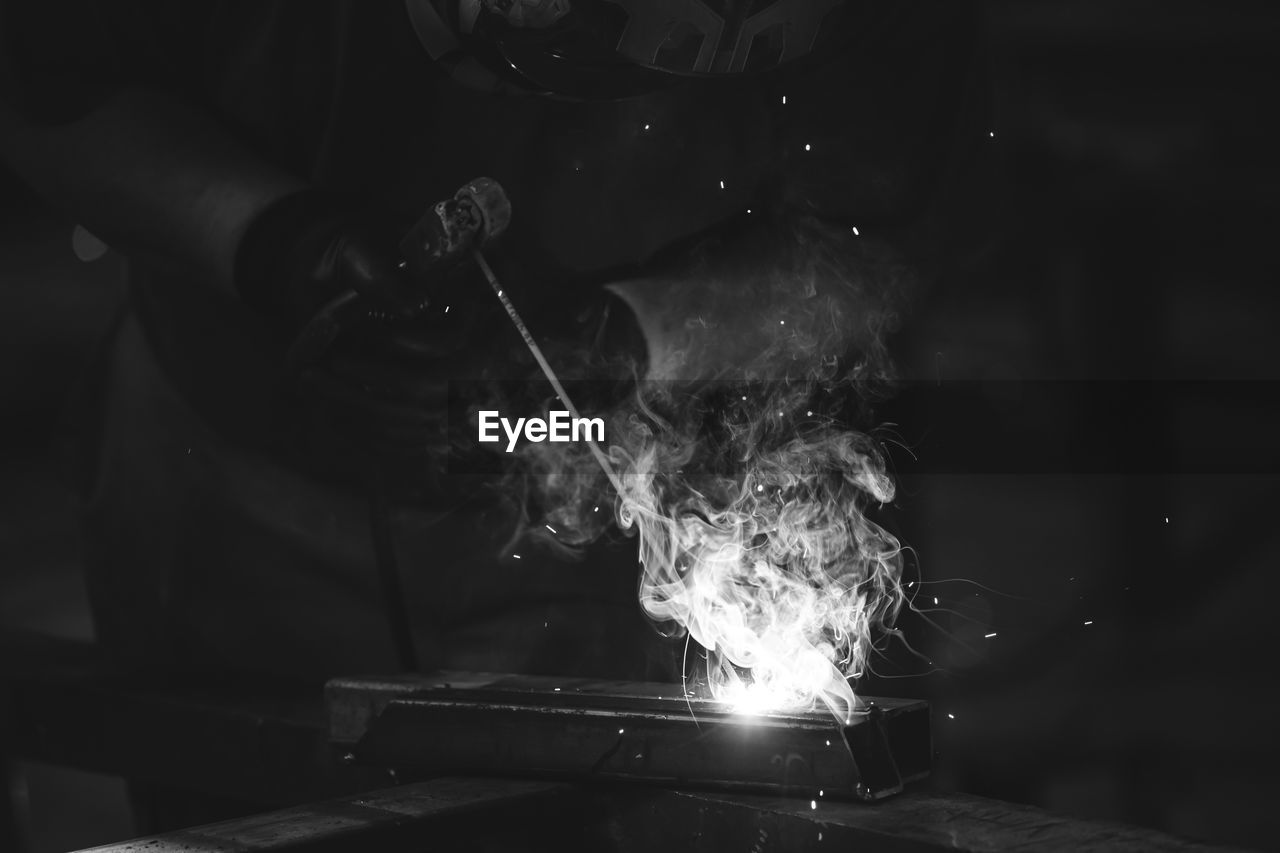 cropped image of man welding metal