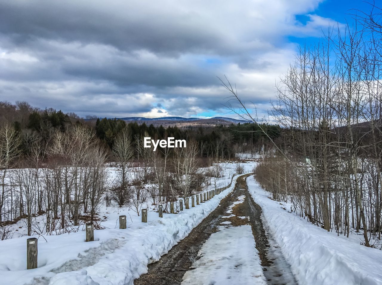 Scenic view of snow covered land against sky