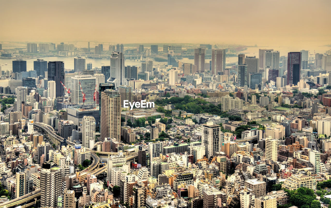 HIGH ANGLE VIEW OF MODERN BUILDINGS AGAINST SKY IN CITY