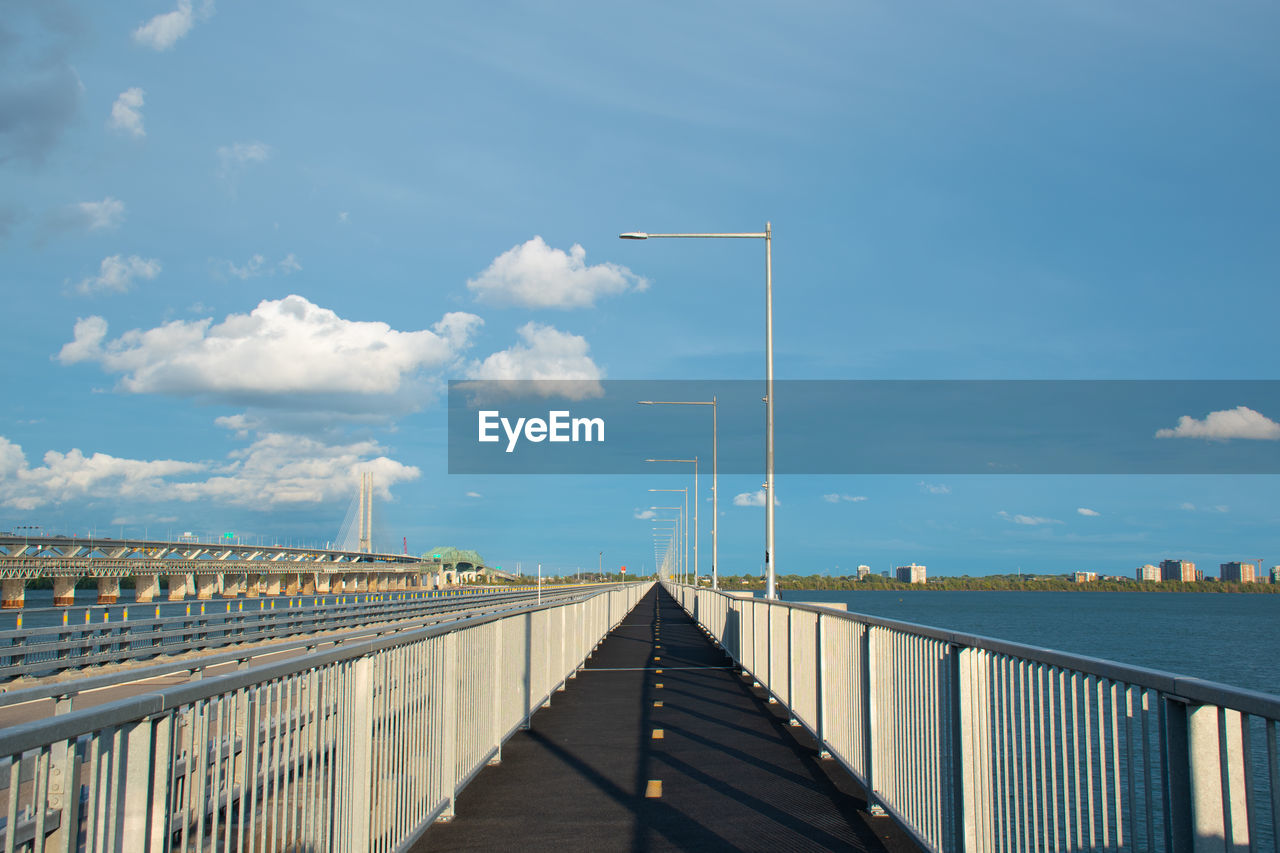Bridge over calm sea against sky