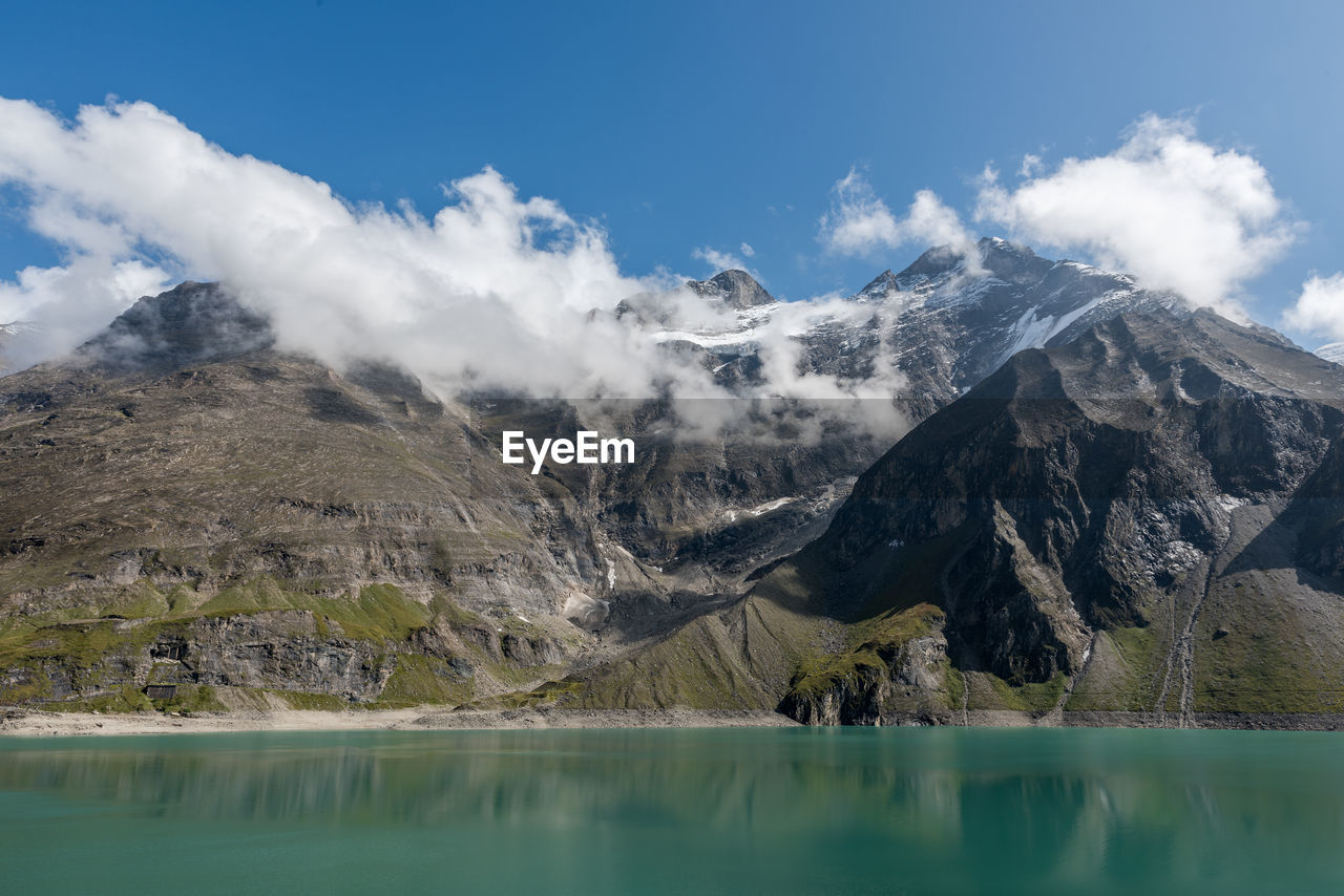 Scenic view of lake and mountains against sky