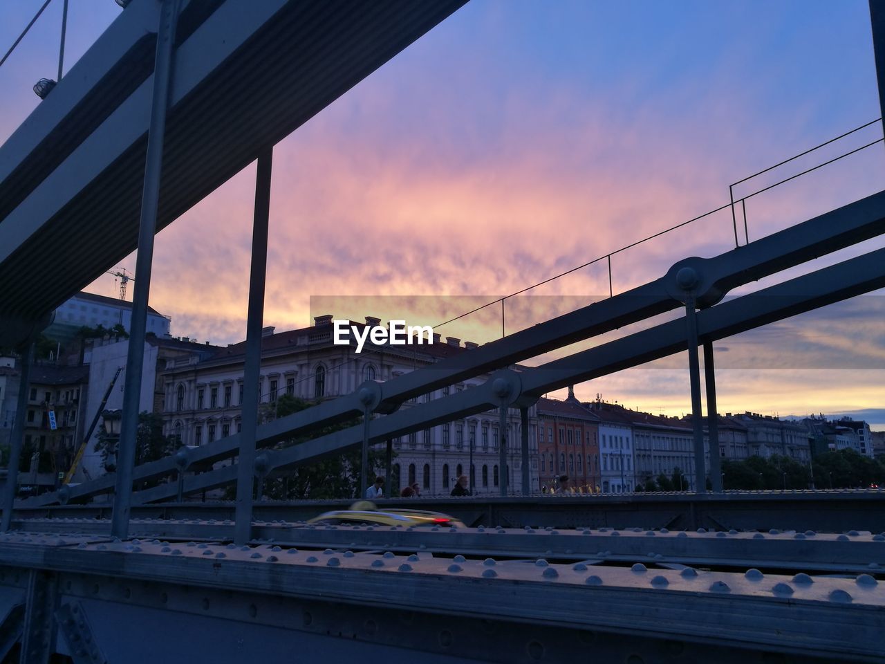 LOW ANGLE VIEW OF SUSPENSION BRIDGE AT SUNSET