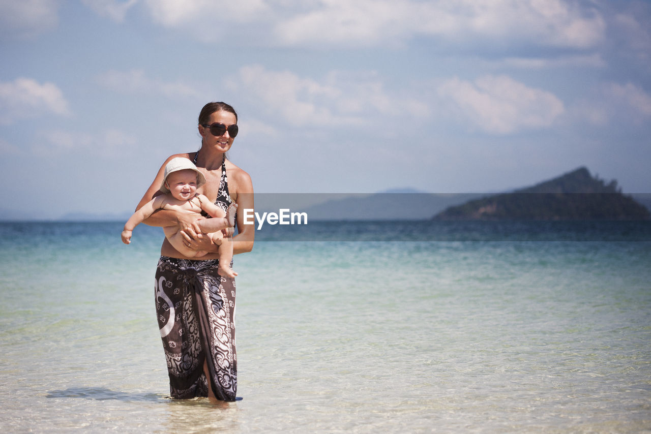 Mother with baby on beach, thailand