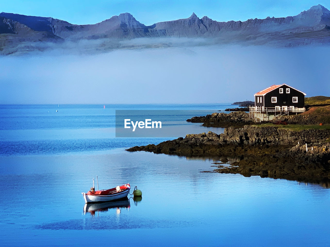 BOAT IN SEA AGAINST SKY