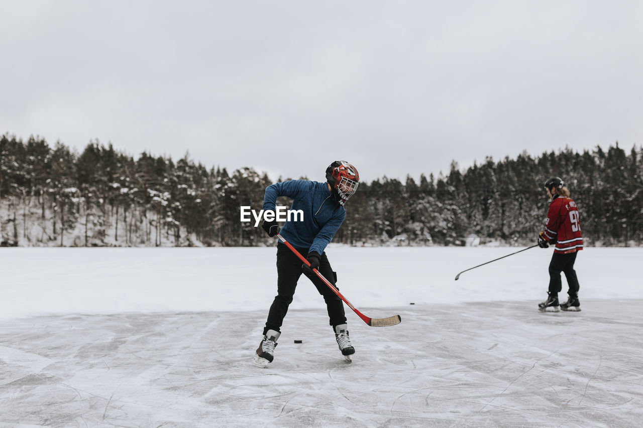 People ice-skating on frozen lake