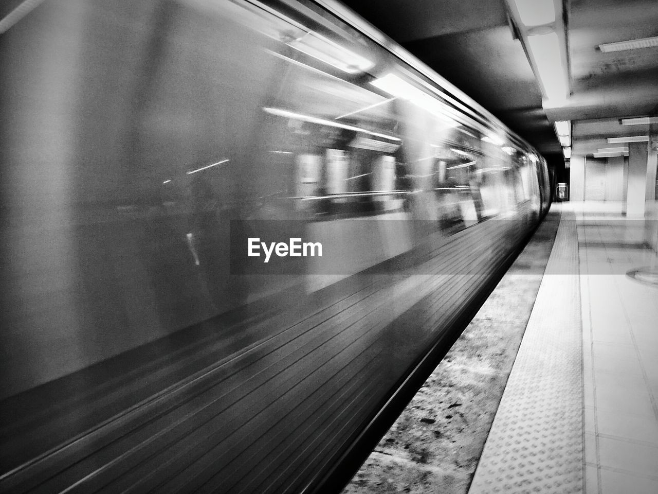 TRAIN ON RAILROAD STATION PLATFORM