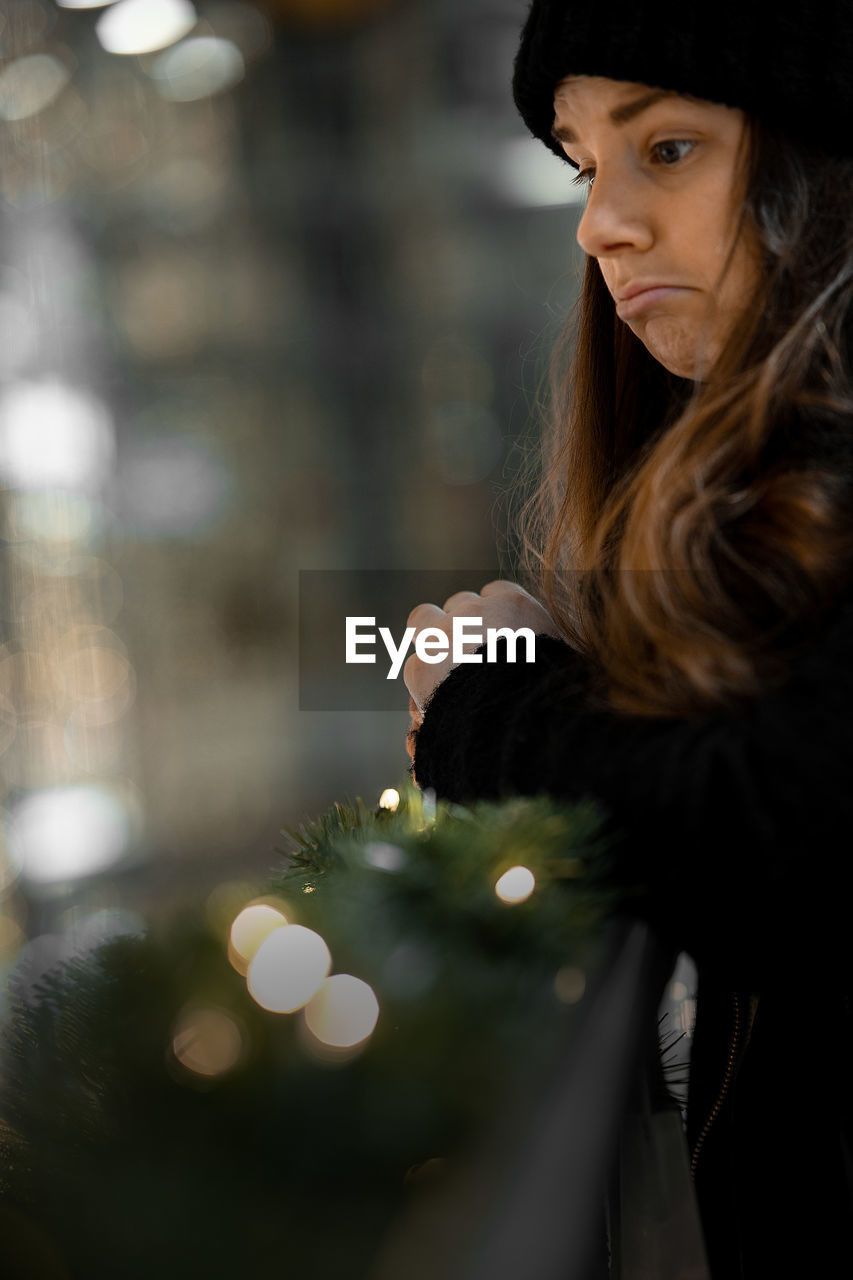 Portrait of young woman looking away outdoors