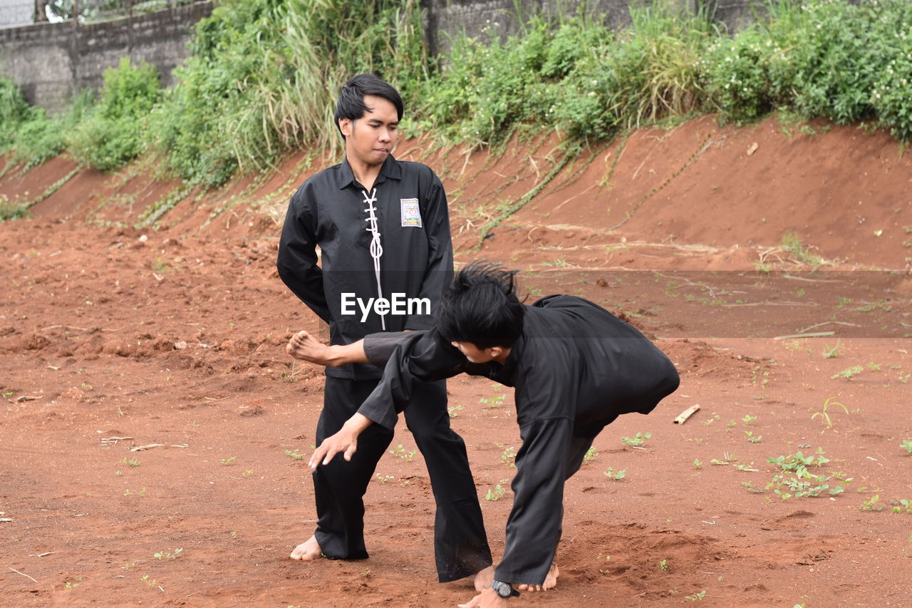 Young men practicing karate outdoors