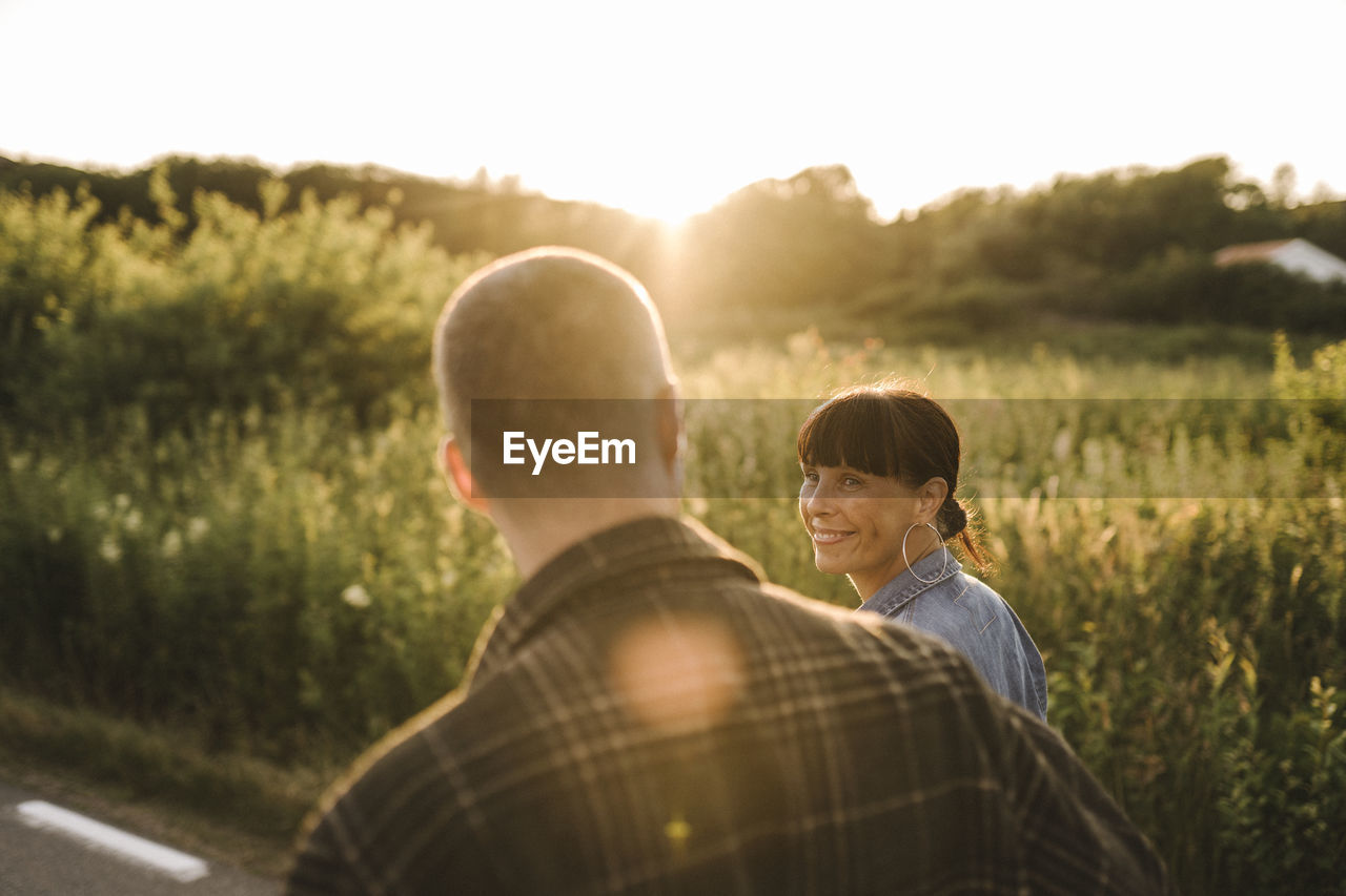 Smiling woman looking at man