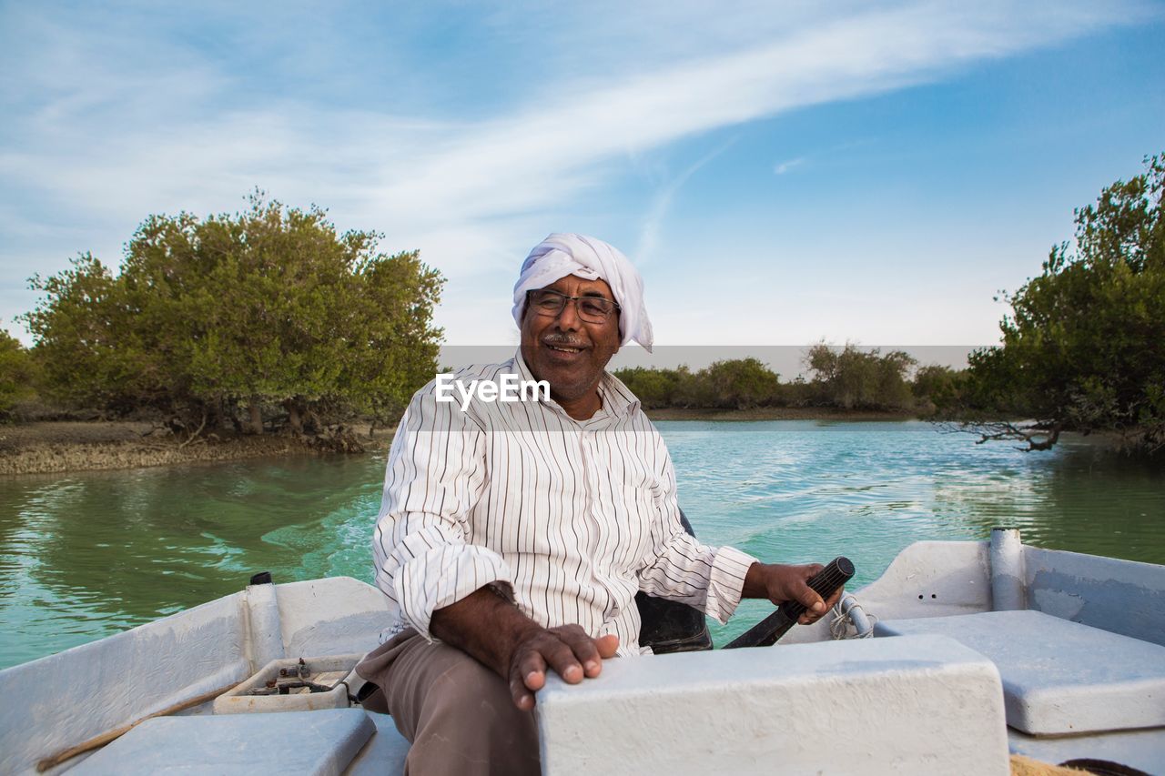 Man sitting in boat on lake 