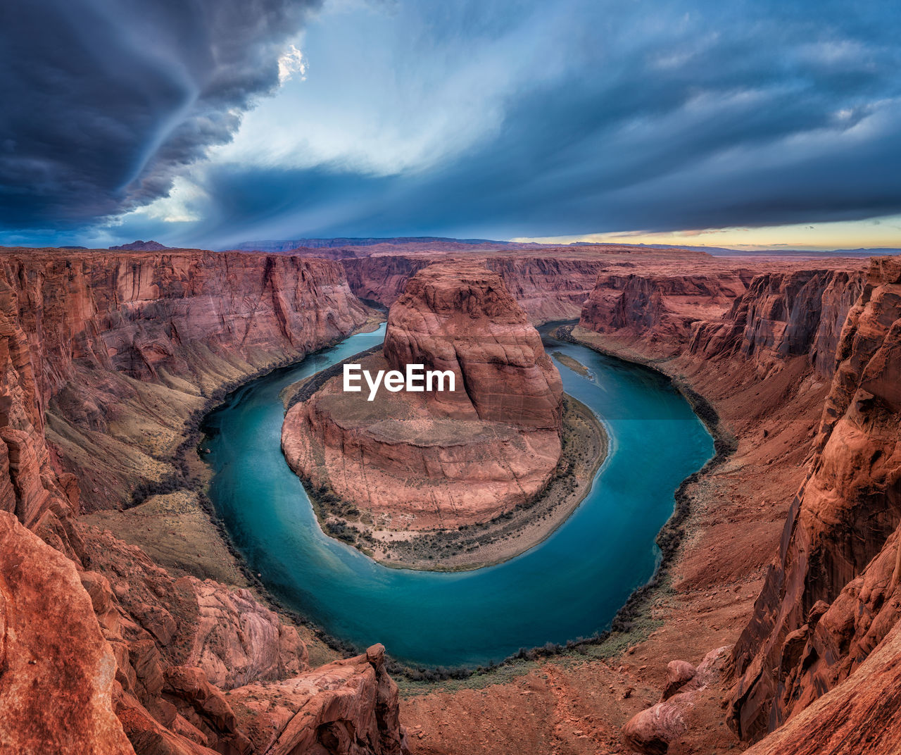 Scenic view of horseshoe bend against cloudy sky