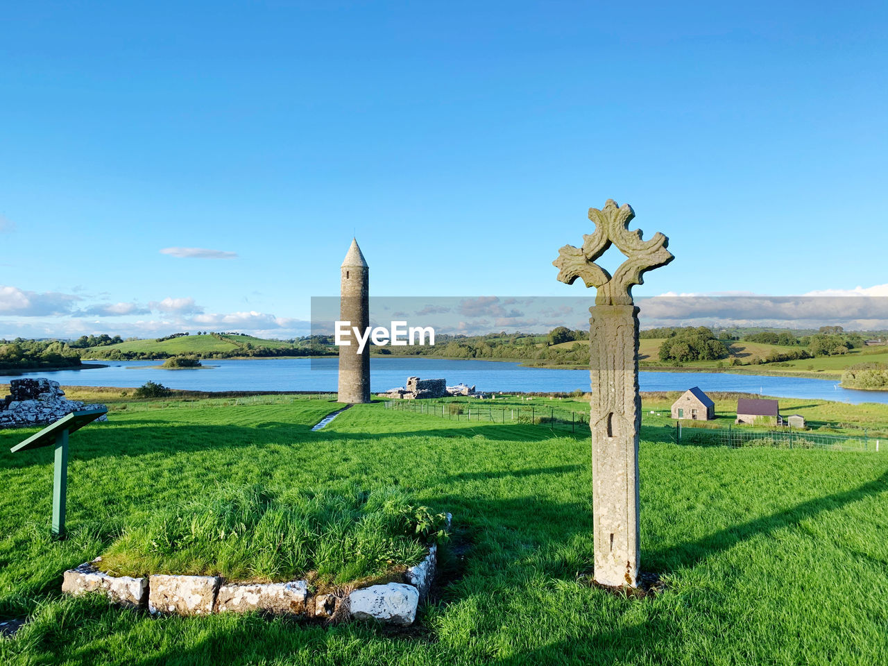 Built structure on field against sky, ancient ireland, celtic, cross, round tower, mysterious 