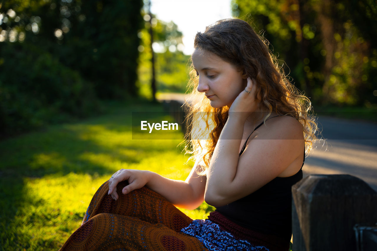 Young woman sitting on field