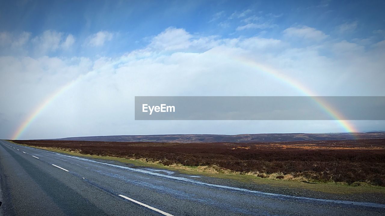 RAINBOW OVER ROAD AGAINST SKY