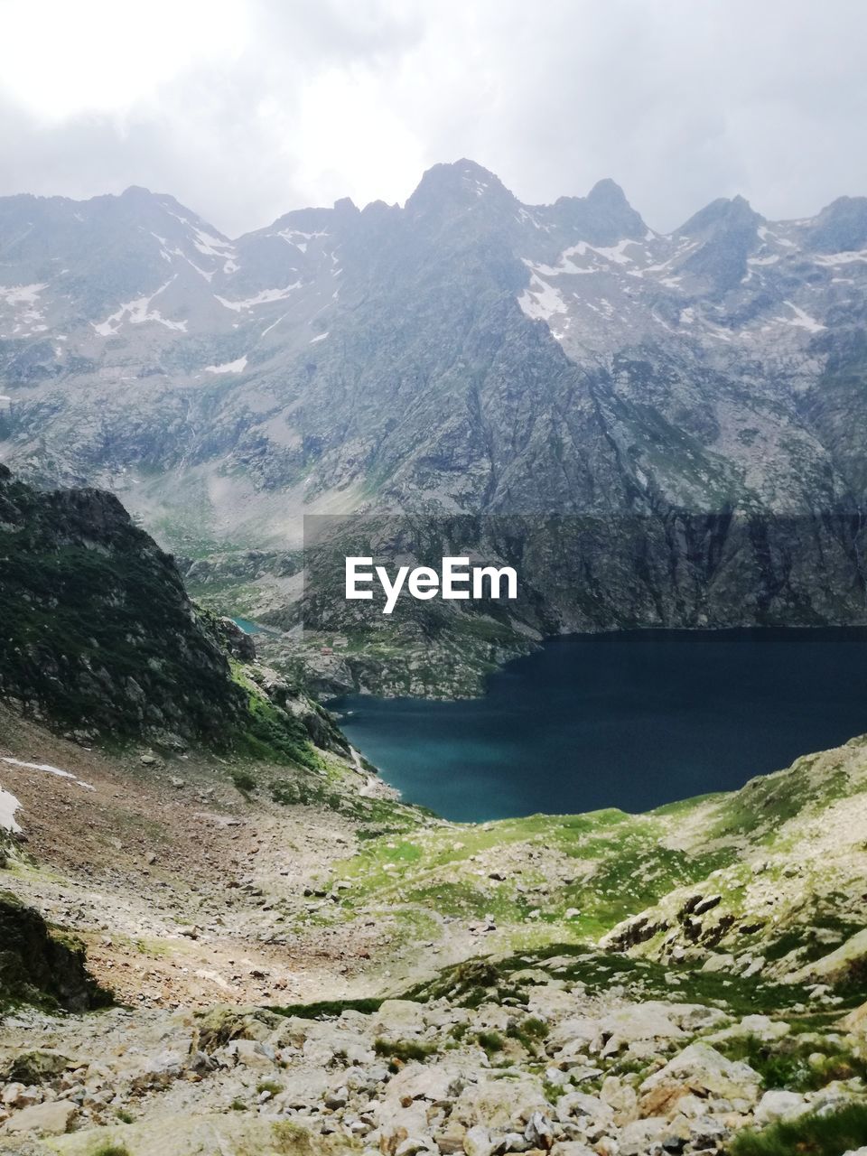 Scenic view of lake and mountains against sky