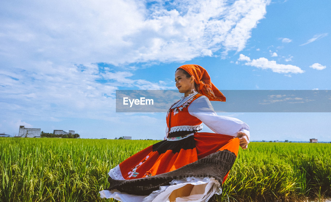 WOMAN STANDING ON FIELD