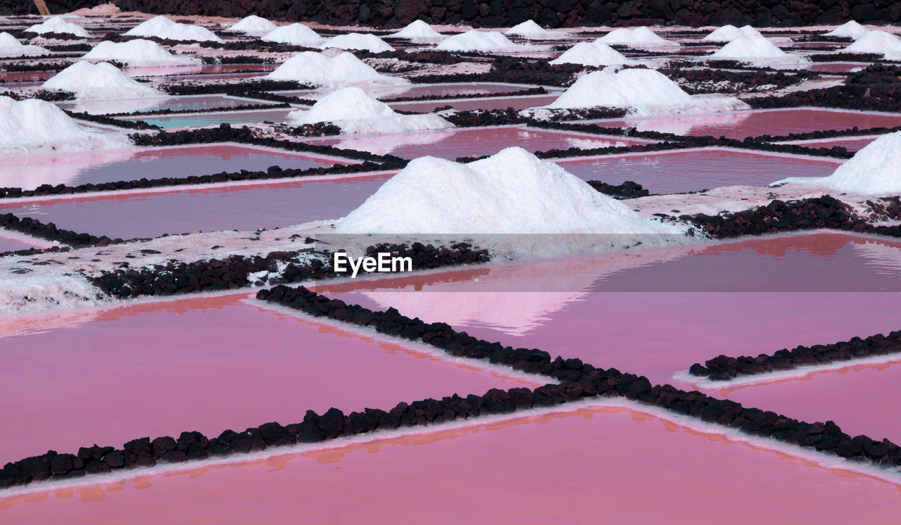 Salt flats farms showing red pink water in la palma canary island 