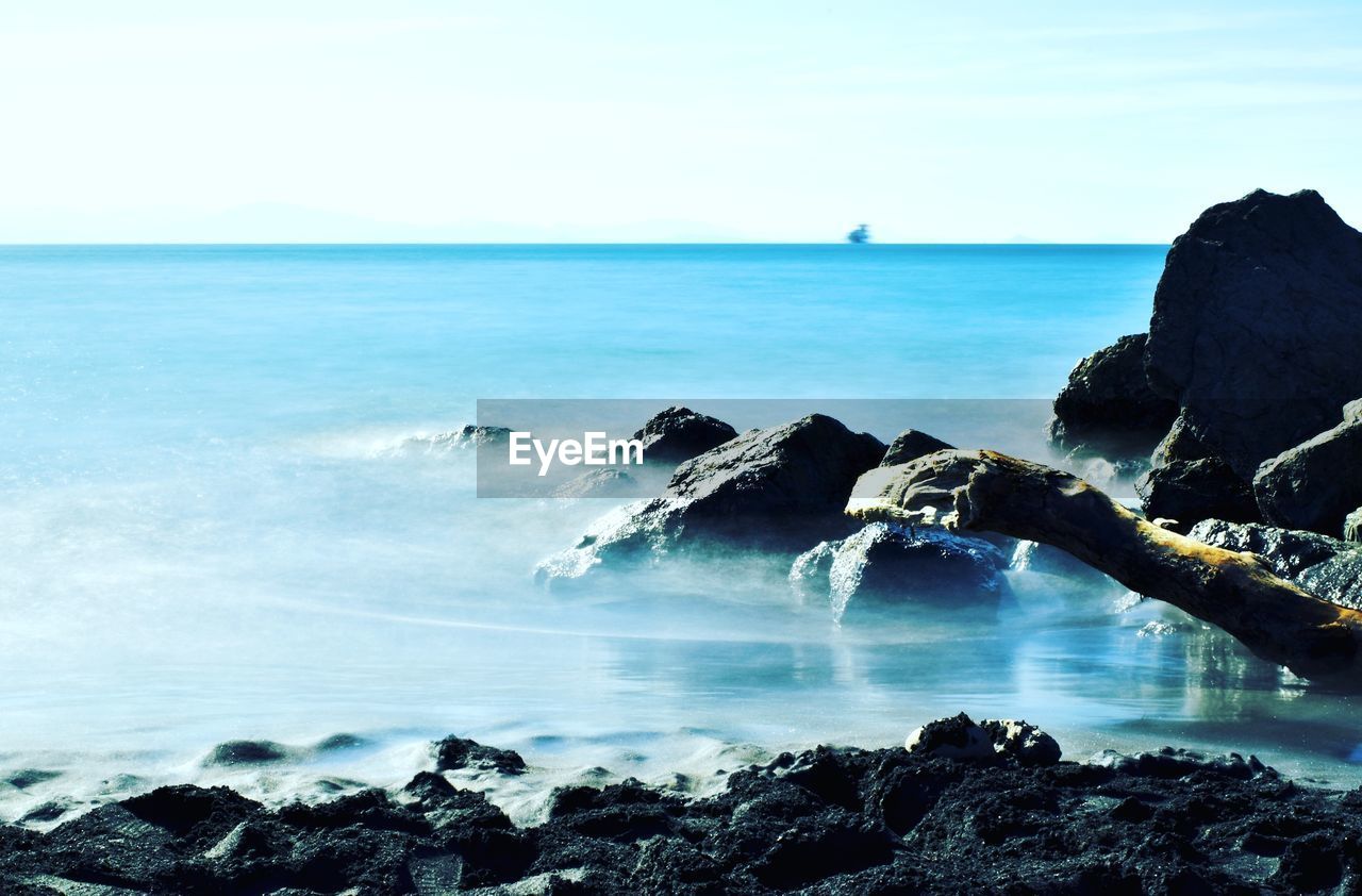 SCENIC VIEW OF SEA AND ROCKS AGAINST SKY