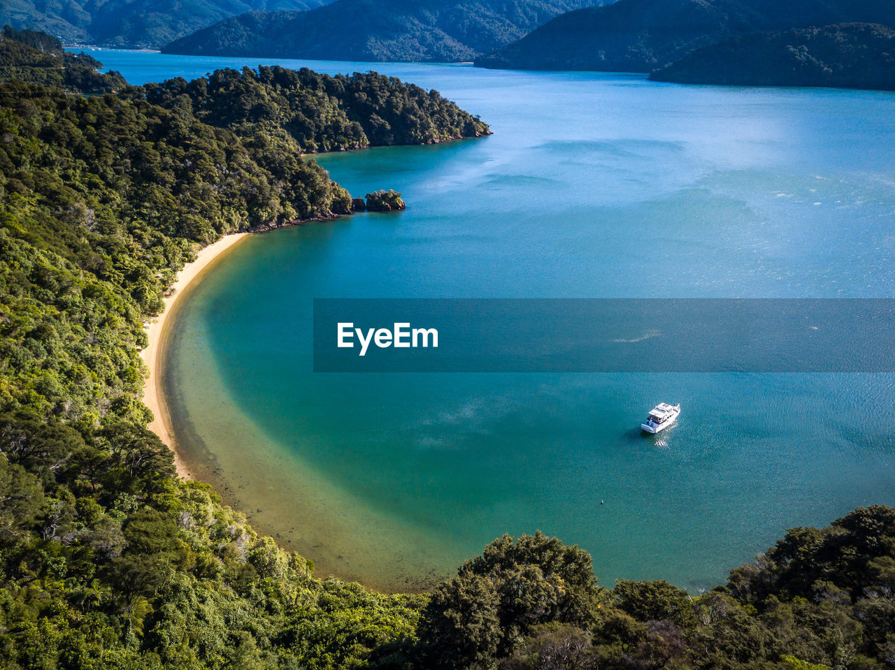 High angle view of bay against clear blue sky