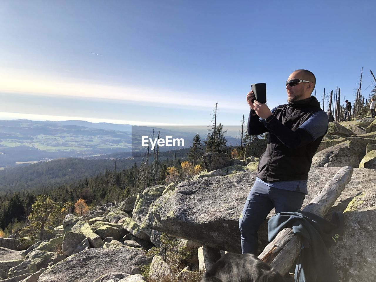 FULL LENGTH OF MAN PHOTOGRAPHING ON MOBILE PHONE