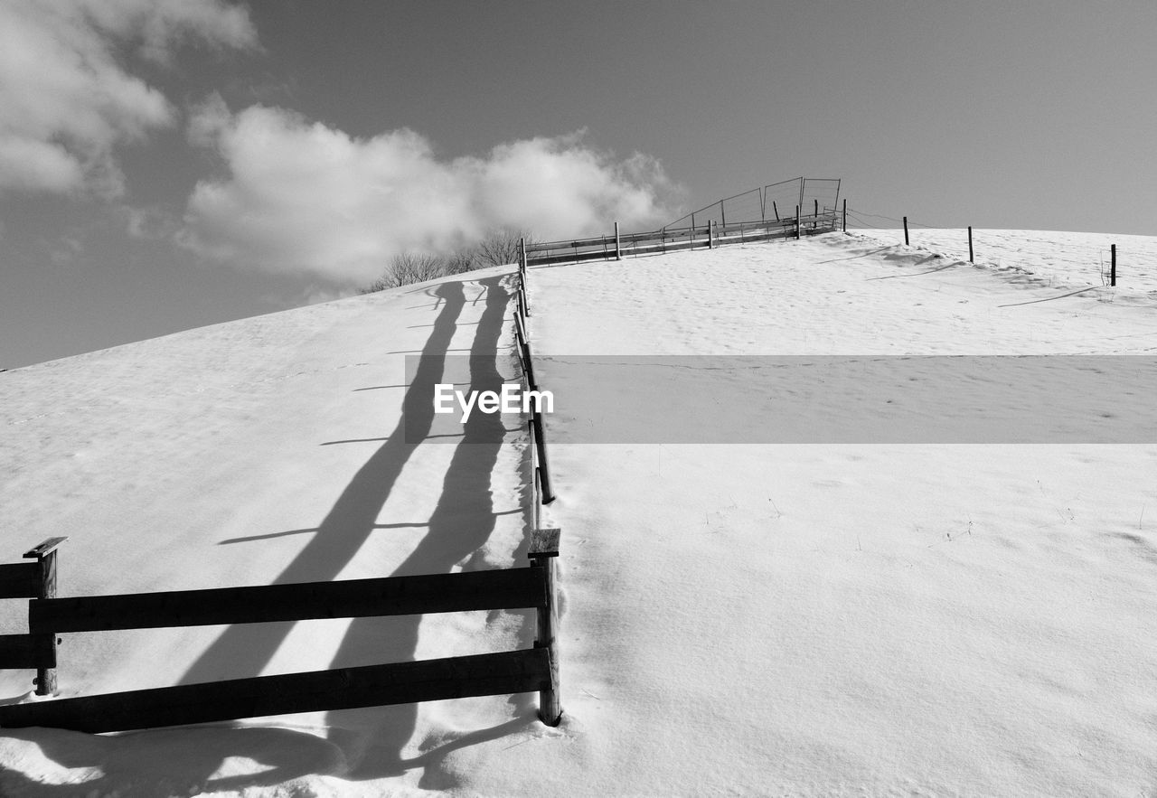 snow, winter, white, sky, nature, cold temperature, black and white, environment, monochrome photography, monochrome, landscape, land, day, cloud, scenics - nature, sunlight, wood, beauty in nature, outdoors, mountain, no people, non-urban scene, fence, architecture, tranquil scene, tranquility