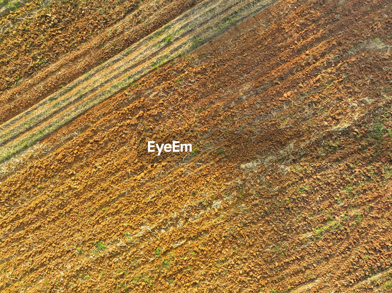 field, agriculture, full frame, soil, backgrounds, no people, pattern, landscape, crop, land, high angle view, environment, day, rural scene, farm, nature, beauty in nature, grass, tranquility, outdoors, scenics - nature, textured, plain, brown, tranquil scene, plant