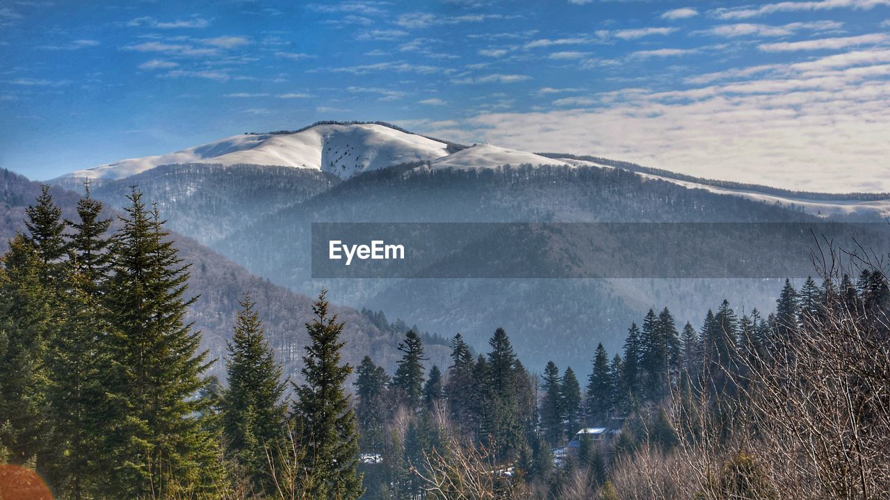 Scenic view of snowcapped mountains against sky