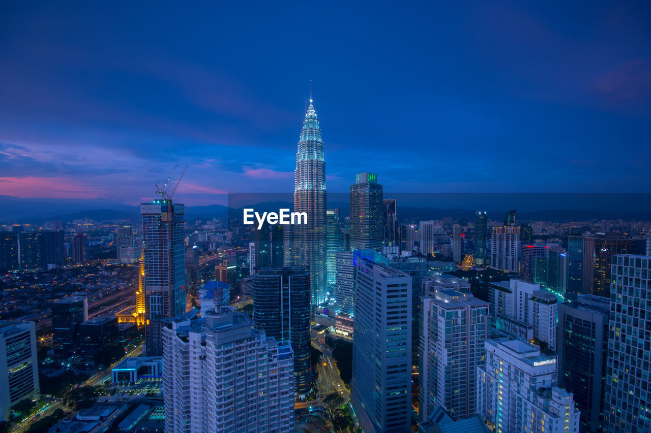 Aerial view of city lit up at night