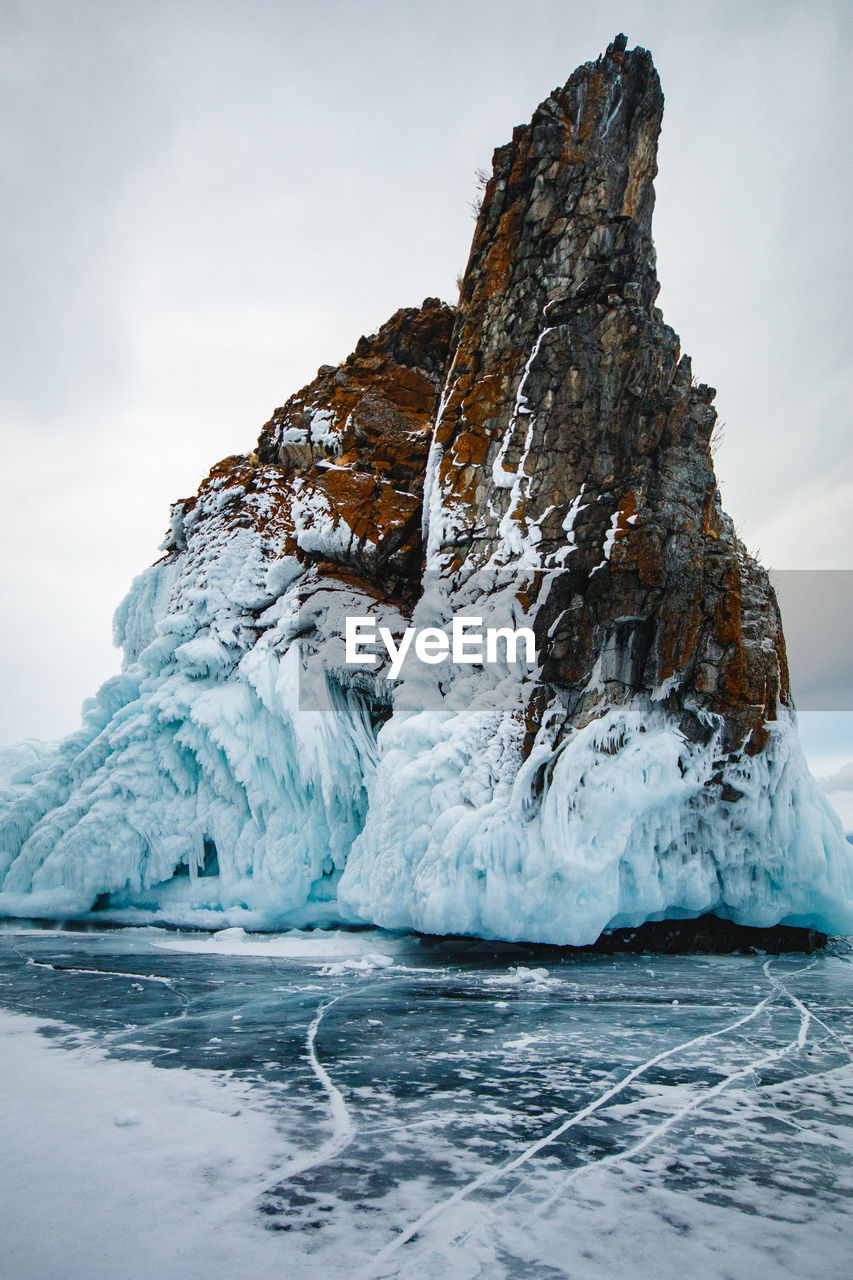 Frozen lake against sky during winter