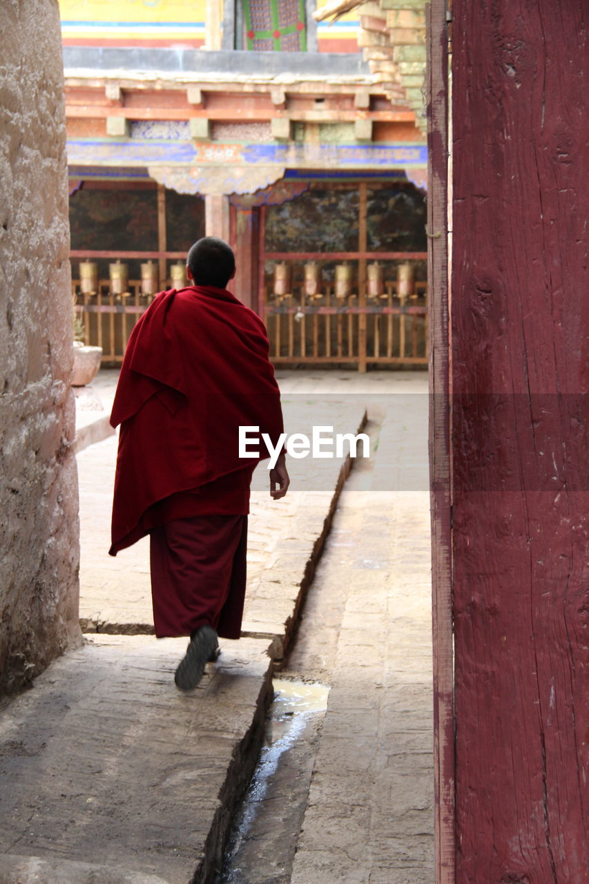 Rear view of man walking in temple